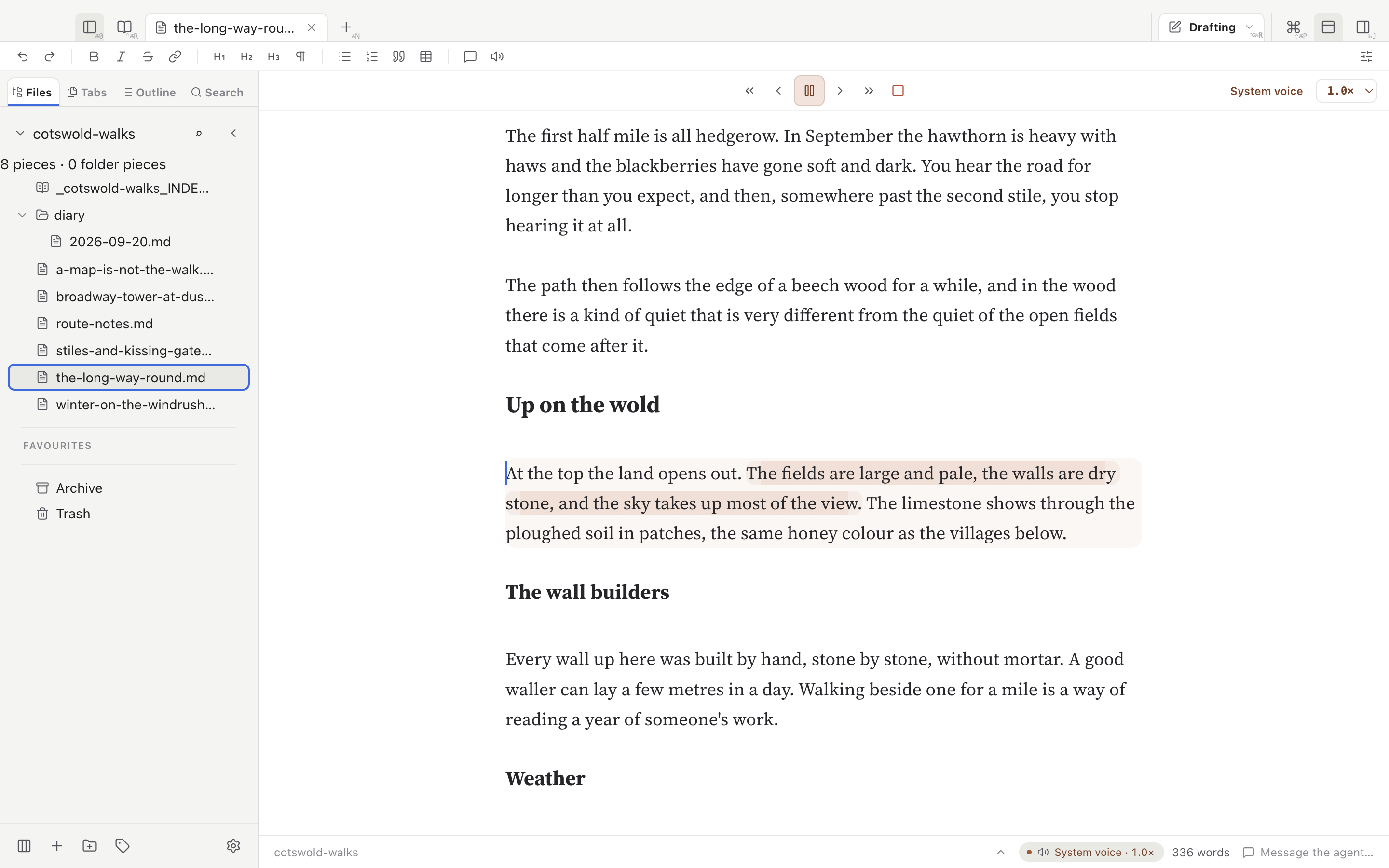 The sample essay being read aloud. The paragraph under Up on the wold has a pale shading, and its second sentence a stronger one. Above the text is a row of controls: previous paragraph, previous sentence, pause, next sentence, next paragraph and stop, with the voice name and a speed menu set to 1.0 on the right. The status bar shows System voice at 1.0 times.
